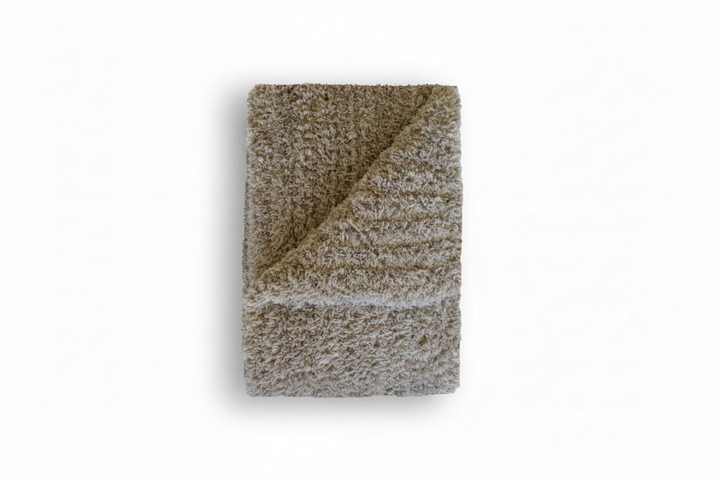 Textured blanket folded on a white background