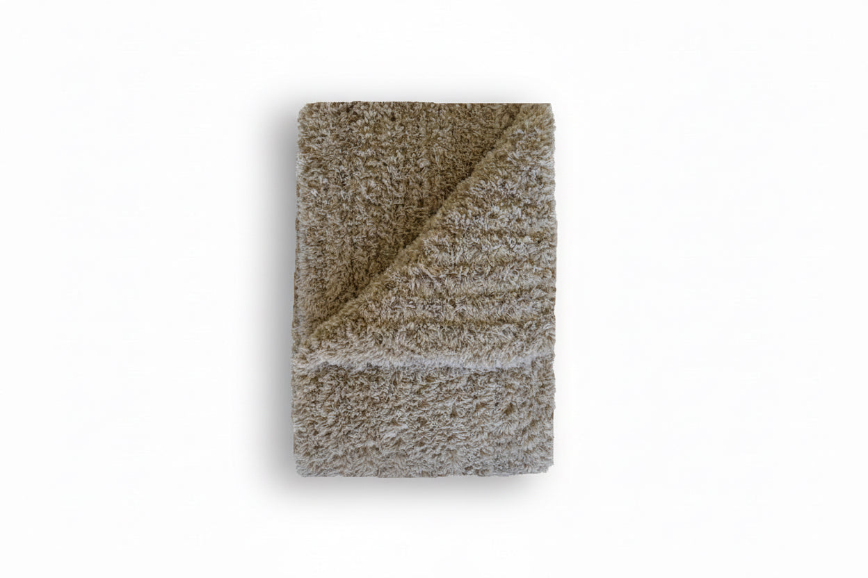 Textured blanket folded on a white background