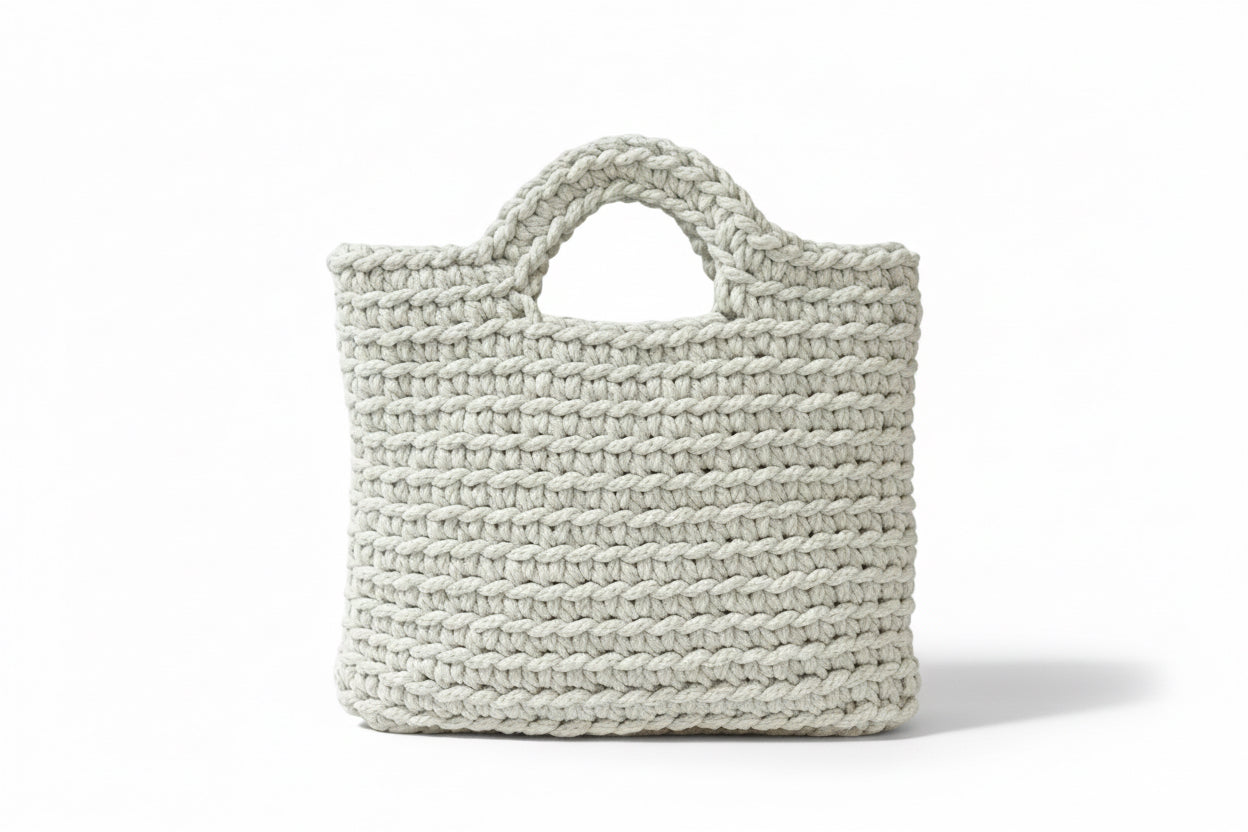 Off white woven handbag on a white background