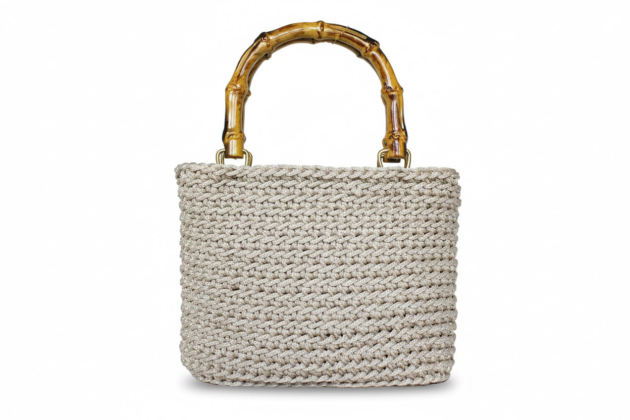 Woven handbag with a bamboo handle on a white background