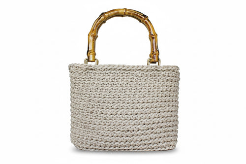 Woven handbag with a bamboo handle on a white background